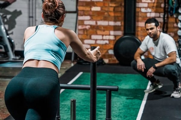 Viv and Jonno pushing sled at Dukes Gym Richmond